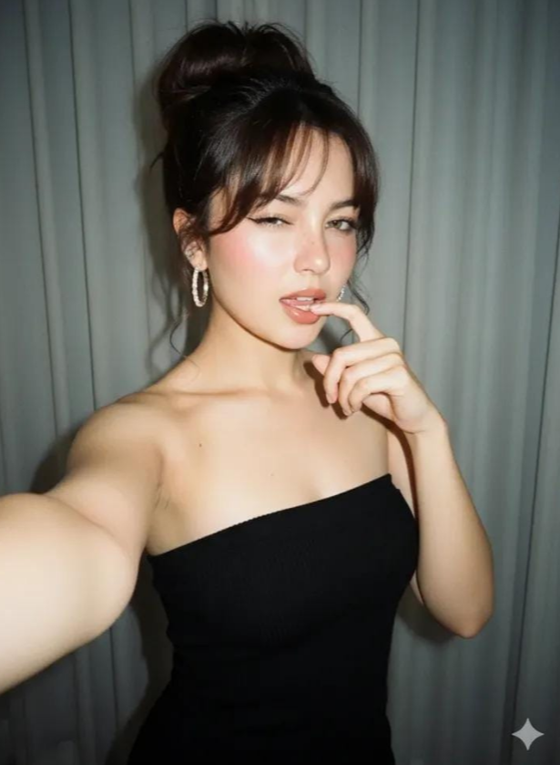 vip prompts: Take a close-up selfie portrait of a young woman standing in a room. She poses with her right hand holding the camera for the selfie, biting her index finger with a flirtatious expression, her right eye winking, and her body tilted slightly to the right.
Her dark brown hair with highlights is tied in a high, messy bun with bangs circling her forehead. She wears diamond hoop earrings.
She appears to have freckles around her nose and cheekbones.
Her makeup is natural, with a subtle pink blush, a defined cat eye eyeliner, curled eyelashes, a brownish-green eye color, and a glossy nude lipstick.
She is wearing a strapless black knit mini dress.

The backdrop is a grayish-white curtain with soft, out-of-focus folds that contrast nicely with the denim dress.
The natural lighting from the sun highlights the subject from the front.  Shot with a 90s camera. Don't change the face.